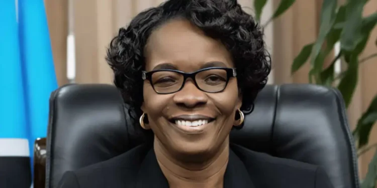 Virginia Albert-Poyotte Hospitalized smiling at her desk