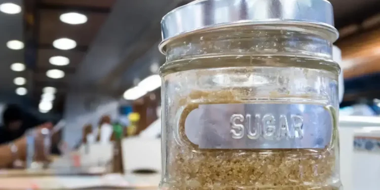 Brown sugar in a glass jar labeled 'sugar,' symbolizing the Caribbean Sugar Association's focus on regional sugar production.
