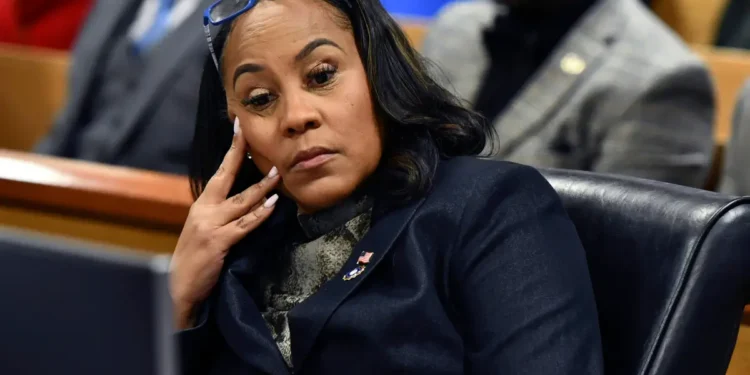 Fulton County District Attorney Fani Willis appearing thoughtful in court during proceedings related to the Fani Willis case.