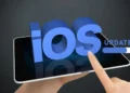Finger tapping on a tablet screen with 3D text 'iOS Update' loading bar, symbolizing the Apple iOS 17.4 Security Update for enhanced protection.
