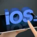 Finger tapping on a tablet screen with 3D text 'iOS Update' loading bar, symbolizing the Apple iOS 17.4 Security Update for enhanced protection.
