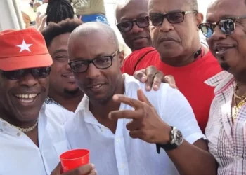 Richard Frederick and Dax Norville in white shirts pictured among followers at a public event, both linked to Saint Lucia money laundering scandal.