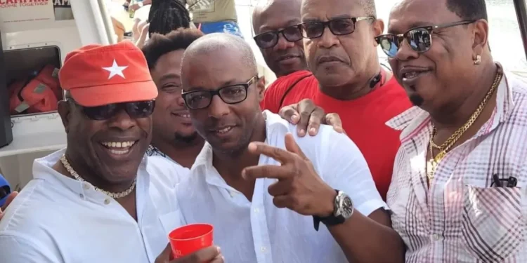 Richard Frederick and Dax Norville in white shirts pictured among followers at a public event, both linked to Saint Lucia money laundering scandal.