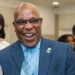 Richard Frederick, pictured smiling in a formal suit, as referenced in the Open Letter to Richard Frederick addressing governance issues.