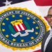 CIP CEO Mc Claude Emmanuel in front of the seal of the Department of Justice