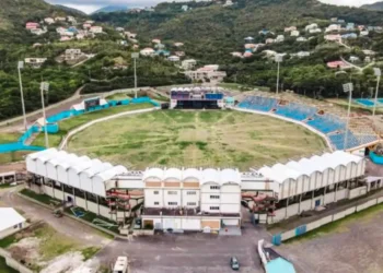 Kenson Casimir discussing Saint Lucia Government Spending with the Darren Sammy Stadium acting as a backdrop