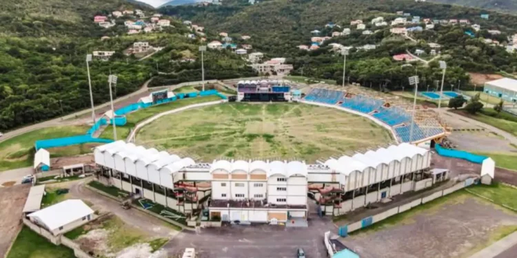 Kenson Casimir discussing Saint Lucia Government Spending with the Darren Sammy Stadium acting as a backdrop
