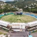 Kenson Casimir discussing Saint Lucia Government Spending with the Darren Sammy Stadium acting as a backdrop