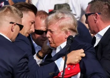 Donald Trump being escorted by Secret Service agents following a Trump rally assassination attempt in Butler, PA on July 13, 2024.