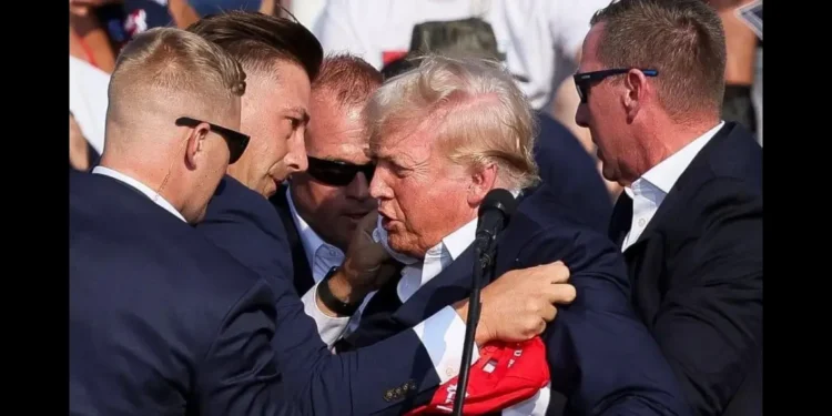 Donald Trump being escorted by Secret Service agents following a Trump rally assassination attempt in Butler, PA on July 13, 2024.