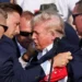 Donald Trump being escorted by Secret Service agents following a Trump rally assassination attempt in Butler, PA on July 13, 2024.