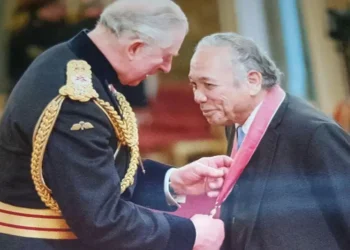 Dr. George Martin Didier, a Saint Lucia healthcare legend, receiving an honor from then-Prince Charles.