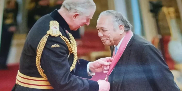 Dr. George Martin Didier, a Saint Lucia healthcare legend, receiving an honor from then-Prince Charles.