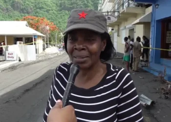 Emma Hippolyte, the district representative for Soufriere Fond St. Jacques, being interviewed on the Soufriere waterfront amidst the aftermath of Hurricane Beryl, reflecting her involvement in partisan politics in disaster relief St. Lucia.