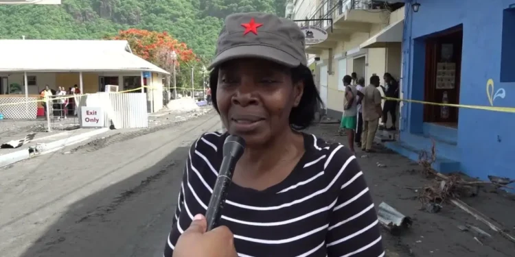 Emma Hippolyte, the district representative for Soufriere Fond St. Jacques, being interviewed on the Soufriere waterfront amidst the aftermath of Hurricane Beryl, reflecting her involvement in partisan politics in disaster relief St. Lucia.