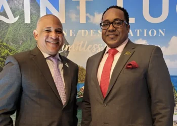 Ernest Hilaire and Thaddeus Antoine standing in front of the Soufriere Pitons, central figures in the Saint Lucia passport fraud scandal