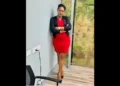 Isa Cyril in a red dress with a black overcoat resigns amid the Saint Lucia CIP Scandal 2024.