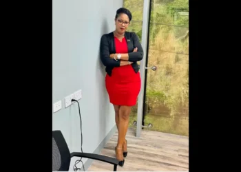 Isa Cyril in a red dress with a black overcoat resigns amid the Saint Lucia CIP Scandal 2024.