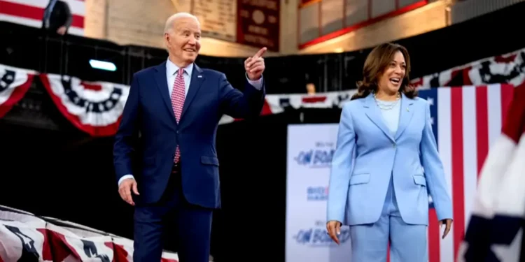 Joe Biden and Kamala Harris on stage during a campaign rally, discussing Biden 2024 re-election decision
