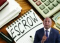 Notepad with the word 'escrow,' a marker, and a calculator representing the financial management involved in the Saint Lucia CIP scandal featuring Ernest Hilaire