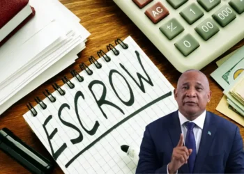 Notepad with the word 'escrow,' a marker, and a calculator representing the financial management involved in the Saint Lucia CIP scandal featuring Ernest Hilaire