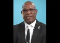 Richard Frederick, the central figure in the Minister of Housing Saint Lucia scandal, wearing glasses and standing in front of a blue background.