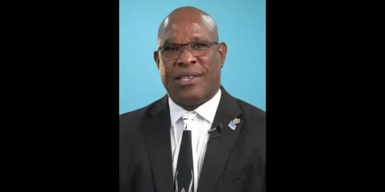 Richard Frederick, the central figure in the Minister of Housing Saint Lucia scandal, wearing glasses and standing in front of a blue background.