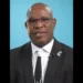 Richard Frederick, the central figure in the Minister of Housing Saint Lucia scandal, wearing glasses and standing in front of a blue background.