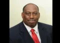 Dr. Dexter James in a red tie, pictured shortly before announcing "Millennium Heights CEO Resigns" amid healthcare challenges.
