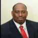 Dr. Dexter James in a red tie, pictured shortly before announcing "Millennium Heights CEO Resigns" amid healthcare challenges.