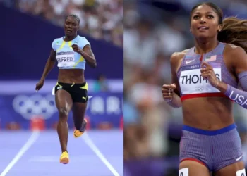 Julien Alfred Olympic silver medal winner standing side by side with Gabby Thomas on the track during the Women's 200m Final at Paris 2024