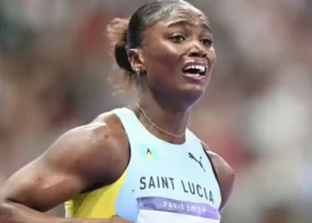 Julien Alfred celebrates her Olympic victory, capturing Julien Alfred Olympic Gold moment as she emotionally embraces her historic achievement.