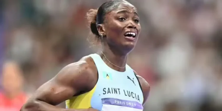 Julien Alfred celebrates her Olympic victory, capturing Julien Alfred Olympic Gold moment as she emotionally embraces her historic achievement.