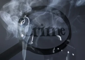 Magnifying glass highlighting the word 'crime,' symbolizing the investigation into the Barre Denis shooting incident that added to Saint Lucia’s rising homicide count.