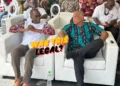Philip J Pierre and Ernest Hilaire seated side by side at a carnival event amidst the ongoing Saint Lucia CIP Board controversy.