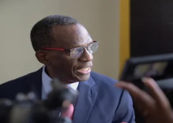 Philip J. Pierre speaking to the media, illustrating his involvement in the "Philip J. Pierre deceitful blame game" over the CIP scandal.