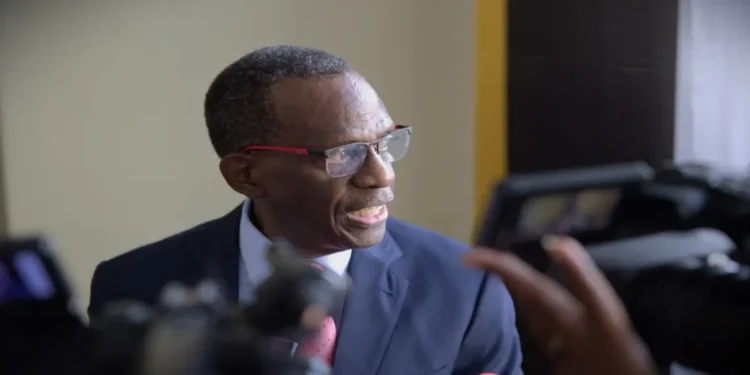 Philip J. Pierre speaking to the media, illustrating his involvement in the "Philip J. Pierre deceitful blame game" over the CIP scandal.