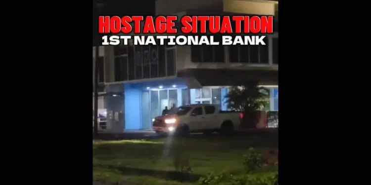 Police responding to the 1st National Bank Robbery at the Choc branch in Saint Lucia, with officers securing the area after the heist.
