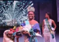 Saint Lucia Carnival Queen 2024 Shan Lucien holding flowers on stage after winning the prestigious Jaycees Queen Pageant in Antigua.