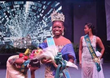 Saint Lucia Carnival Queen 2024 Shan Lucien holding flowers on stage after winning the prestigious Jaycees Queen Pageant in Antigua.