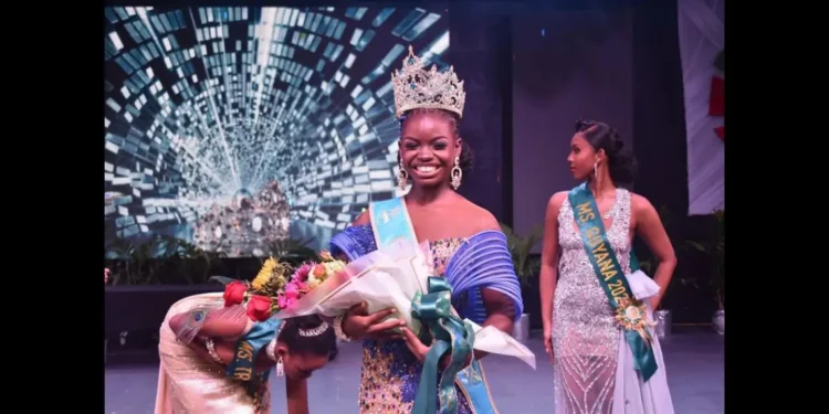 Saint Lucia Carnival Queen 2024 Shan Lucien holding flowers on stage after winning the prestigious Jaycees Queen Pageant in Antigua.