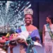 Saint Lucia Carnival Queen 2024 Shan Lucien holding flowers on stage after winning the prestigious Jaycees Queen Pageant in Antigua.