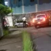 Saint Lucia ex-cop shooting crime scene with police vehicle, yellow tape, and officer standing guard amidst rising crime under Philip J. Pierre’s watch