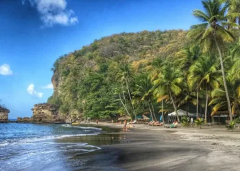 Stunning view of Anse Mamin Beach, one of the hidden gems in Saint Lucia, featuring pristine sands and crystal-clear waters surrounded by lush tropical vegetation.