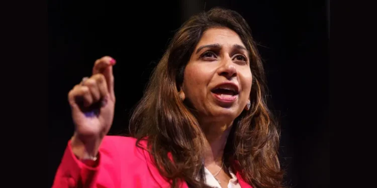 Suella Braverman leadership spotlight as she dons a pinkish outfit, embodying the pivotal decision not to pursue Tory leadership, influencing Conservative Party dynamics.