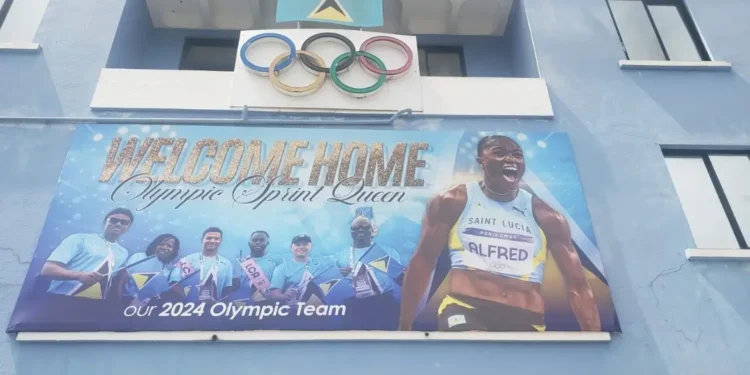 Billboard showcasing Julien Alfred in Saint Lucia, celebrating her historic Olympic wins, as part of the Julien Alfred Homecoming festivities