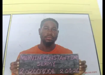 Bordelais Prison Escape: Mervin Jeremie Constantine holds a board with his name and prison number after walking out of the facility.