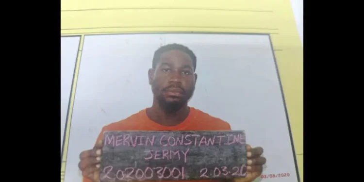 Bordelais Prison Escape: Mervin Jeremie Constantine holds a board with his name and prison number after walking out of the facility.