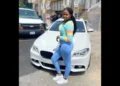 Christina Cephinis, the Saint Lucian woman at the center of a Brooklyn homicide investigation, posing in front of a white BMW.