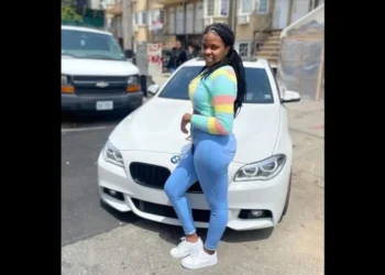 Christina Cephinis, the Saint Lucian woman at the center of a Brooklyn homicide investigation, posing in front of a white BMW.